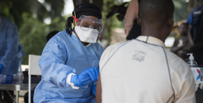  A member of the ring vaccination team vaccinates a man in Bosolo village.